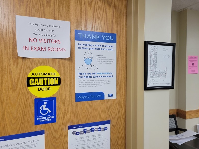 Signs on the door of a Barnes-Jewish Hospital clinic show various pandemic-related restrictions. The region's hospitals are seeing unprecedented numbers of pediatric COVID cases. - DANNY WICENTOWSKI