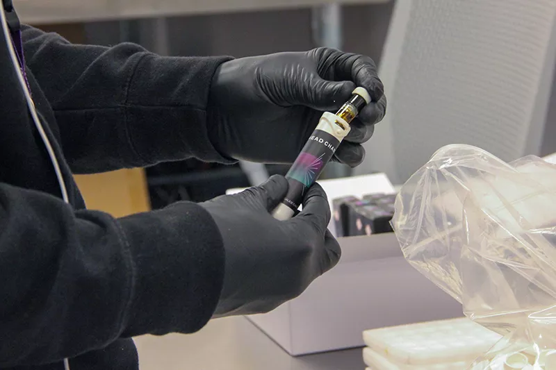 A Curador employee packages a Head Change "sauce cart" at the company's lab. - DANNY WICENTOWSKI