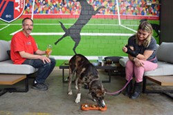 Ruby Rose tries a "Doggie Flight" as George Graff and Lisa Wardein sit outside on Bar K's patio. - CASSIDY WAIGAND