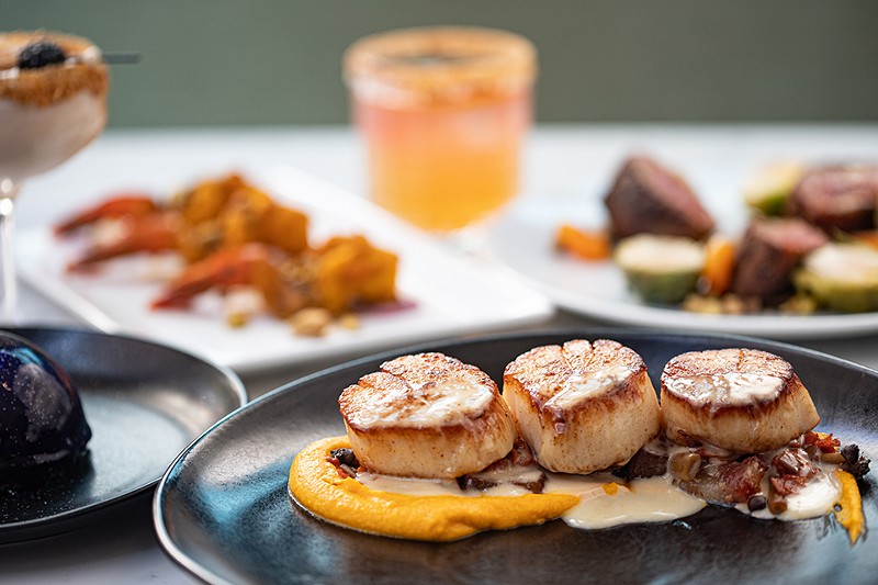 Cast iron-cooked scallops are served with carrot puree, braised leeks, mushrooms, lardon and charred lemon buerre blanc. - MABEL SUEN
