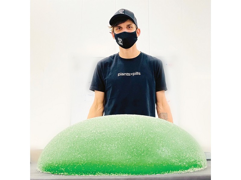 Good Day Farm Head Chef Peter Sturdevant poses with the world's largest cannabis gummie. - Courtesy of Good Day Farm