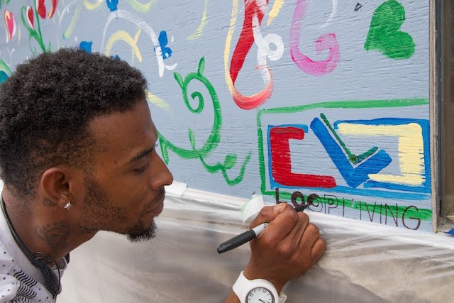 Jomar Jackson paints at Loop Living. If you're an artist having an impact on your community, we want to hear about it. - COURTESY OF PAINTING FOR PEACE IN FERGUSON, A CHILDREN'S BOOK