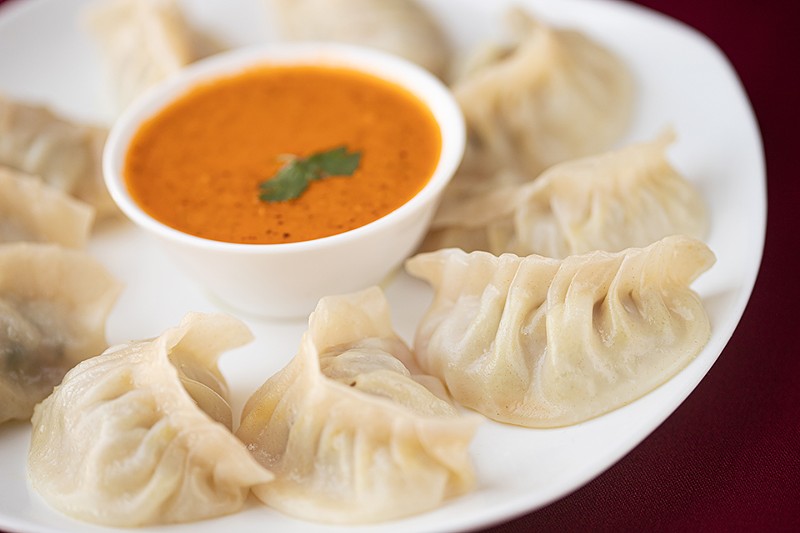 The jhol momo are served with a bowl of reddish-orange, sauce-like soup that is light yet zesty with herbs and spices balanced with exactly the right amount of acidity. - Mabel Suen