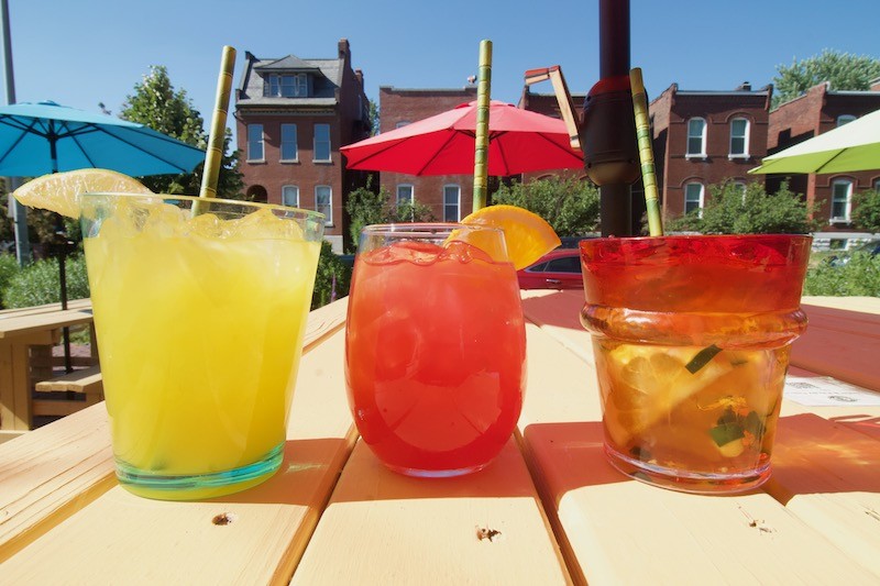 Station No. 3's Diego’s Margarita, Frida’s and Pimm’s Cup set against the restaurant's patio. - Lulu Nix
