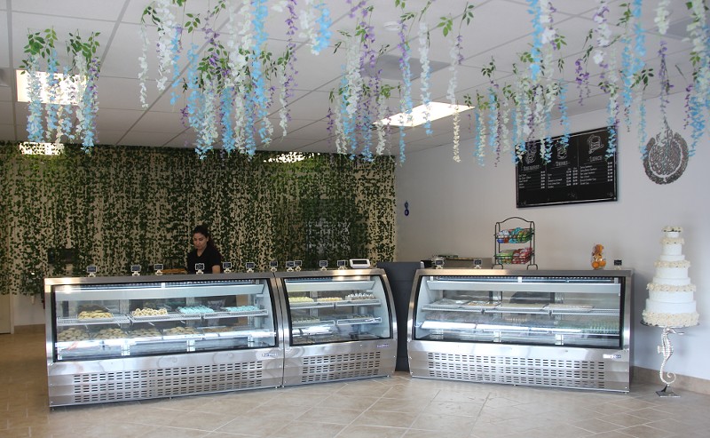 Ahmadi hung garlands of flowers from the ceiling and a wall of ivy separates the front of the bakery from the kitchen. - Jessica Rogen