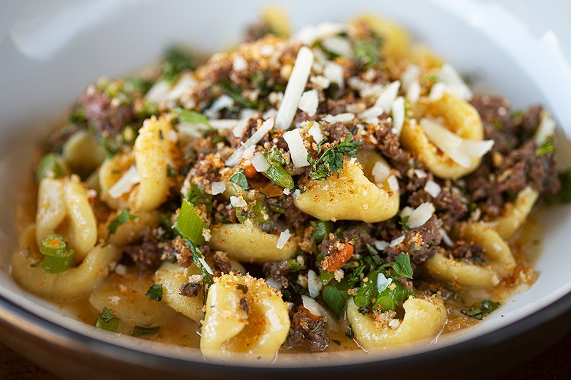 The orecchiette is served with lamb sausage and broccolini.