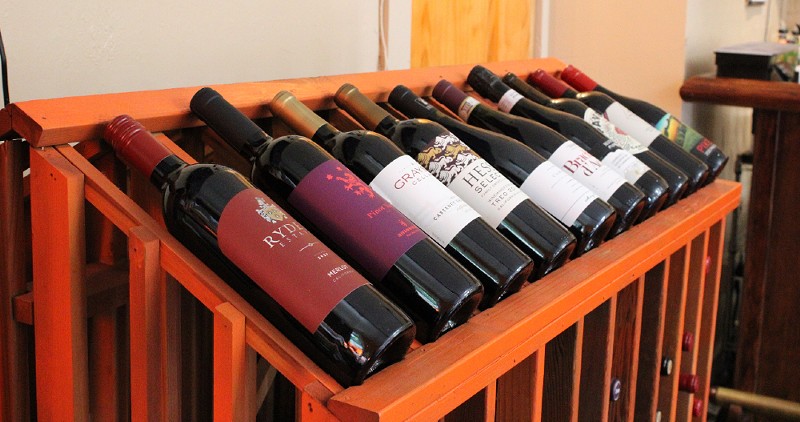 A rack of holds wine bottles.