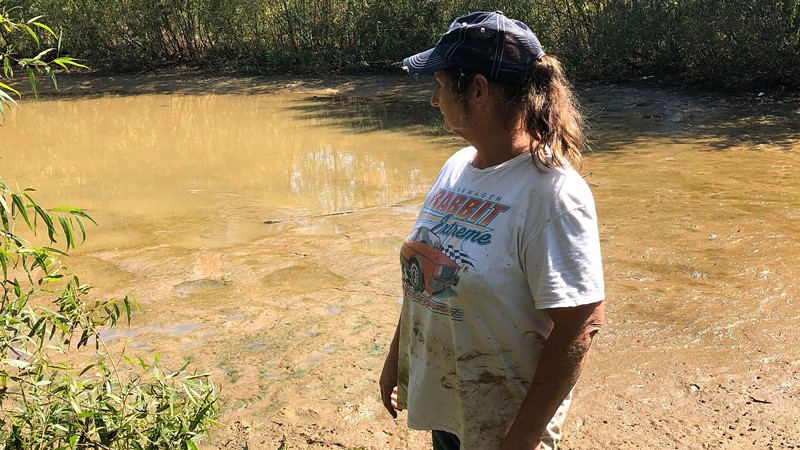Connie Goodwin at the now mostly-drained pond where her son's murderers left his body.