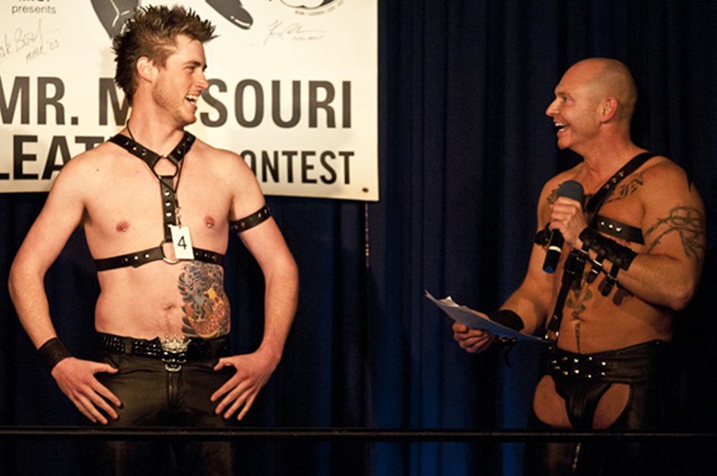 Two Mr. Missouri Leather contestants stand on stage.