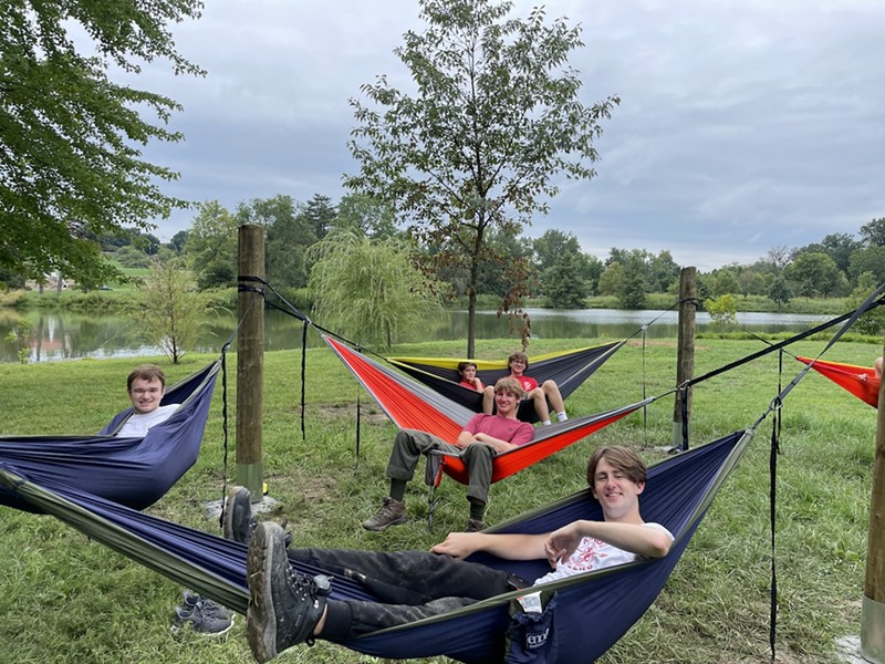 Zachary Noland (center, in red) hammocking with friends in the new hammock garden in Forest Park. - COURTESY OF AMY NOLAND