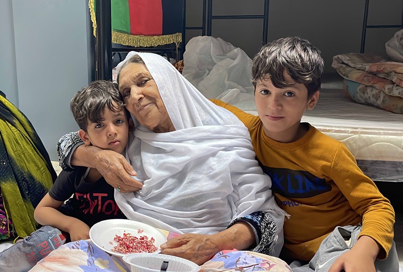 BiBi Asifa Danishyar, Latifa's mother, hugs two boys in front of a bed.