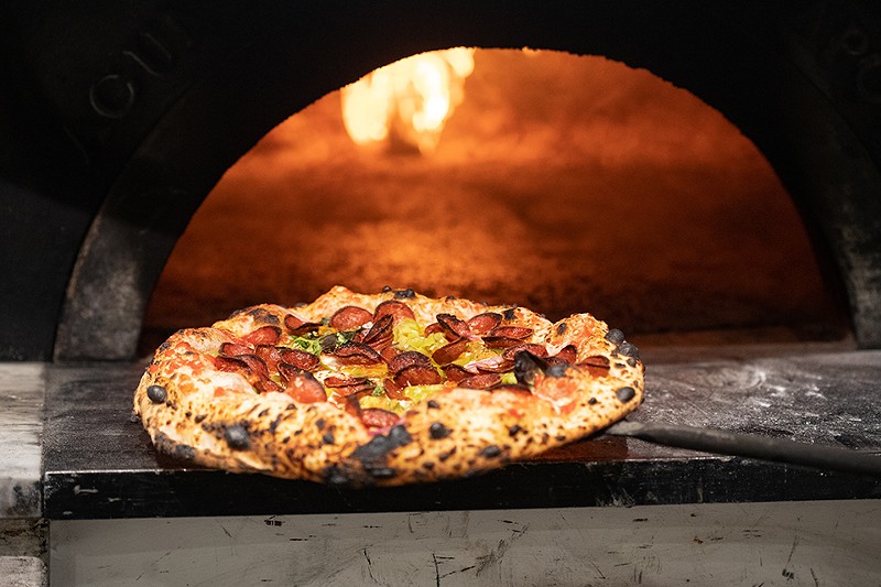 The pizzas are cooked in an imported Italian wood-fired oven.