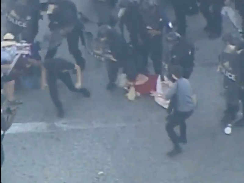 Video from Fox 2 shows Laura Jones on the ground amid police officers.