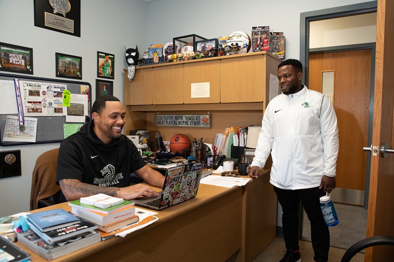 Assistant athletic director Bryan Turner and athletic director Brocklon Chatman share a laugh in Turner's office, which he sometimes calls his "home."
