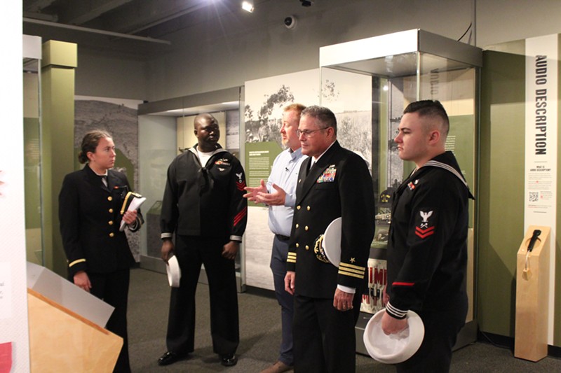 Mikall Venso, military and firearms curator for the Missouri Historical Society and chief curator of Vietnam: At War and At Home, leads a tour through the exhibit.