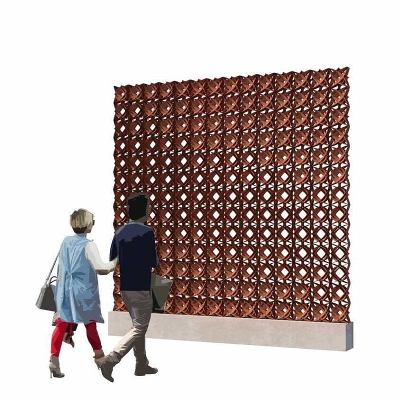 Two people walk past an installation - a red clay sculpture.