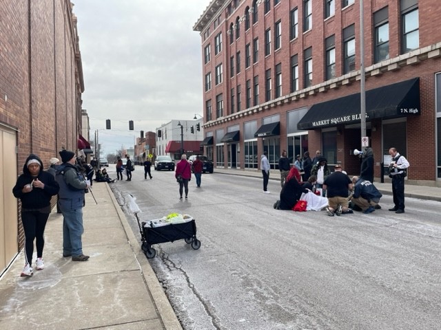People attend to a protester who was injured trying to stop a truck from driving through a protest in downtown Belleville.