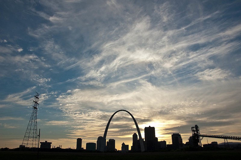A photo shows the St. Louis skyline at sunrise.