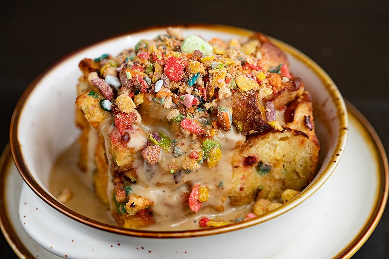The bread pudding is served with cereal milk and cereal granola.