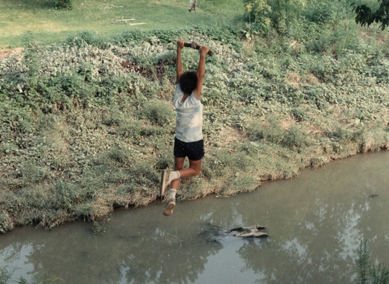 An undated photo from the 1980s, of a child swinging from a rope into Coldwater Creek. The photo is from a scrapbook kept by Sandy Delcoure, who lived on Willow Creek in Florissant and donated the scrapbook to the Kay Drey Mallinckrodt Collection. Only one of the photographs from the scrapbook includes any information, which read: “Willow Creek children on Cold Water [sic] Creek. We can’t keep the children away from the creek. The only alternative is to get it cleaned up.”