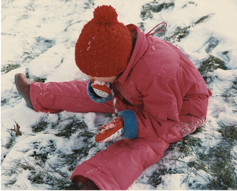 An undated photo from the 1980s, of a child eating snow near the banks of Coldwater Creek. The photo is from a scrapbook kept by Sandy Delcoure, who lived on Willow Creek in Florissant and donated the scrapbook to the Kay Drey Mallinckrodt Collection.