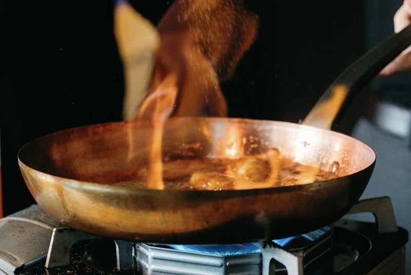 A dish gets the flambé treatment. - COURTESY OF NAPOLI SEA