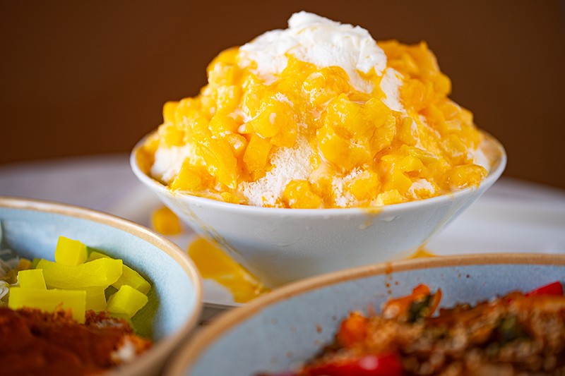 The mango bingsu features both chunks of fruit and mango sauce.
