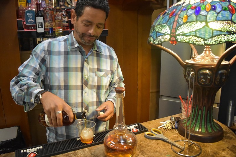 David Boykin pours a drink at Frenchtown Audio's in-house bar. - DANIEL HILL
