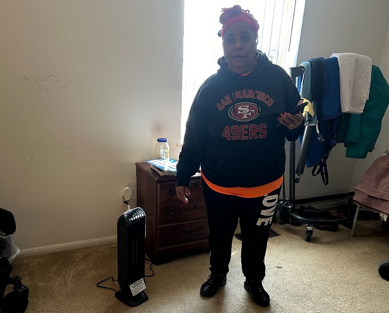 Sherrie Robertson shows the space heater she had to use to endure a long cold snap with no heat in her apartment. - MIKE FITZGERALD