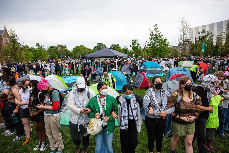 Demonstrators lock arms in front of a temporary encampment on Saturday, April 27, 2024, at Washington University. - ZACHARY LINHARES