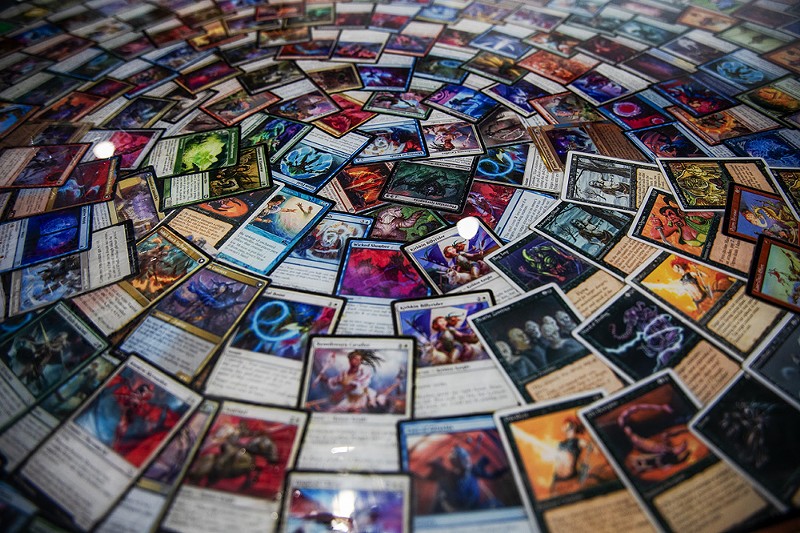 Magic the Gathering cards cover a table inside of Dirty 20. - ZACHARY LINHARES