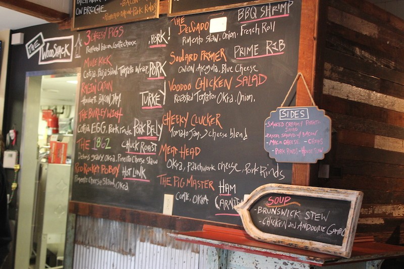 A chalkboard displays menu offerings. Customers order at the the counter. - PHOTO BY SARAH FENSKE