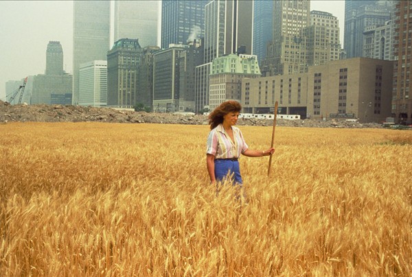 Agnes Denes, Wheatfield—A Confrontation: Battery Park Landfill, Downtown Manhattan, with Agnes Denes Standing in the Field, 1982. Courtesy the artist and Leslie Tonkonow Artworks + Projects, New York. Photo: John McGrall.