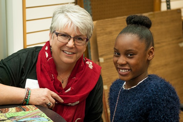 Jeane Vogel meets with Divine Robinson, a fourth grader at Washington Elementary, on interview night. - COURTESY OF THE BLOOMING ARTISTS PROJECT