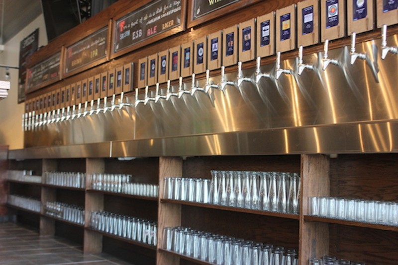 Glasses are stored under the row of taps for easy access. - PHOTO BY SARAH FENSKE