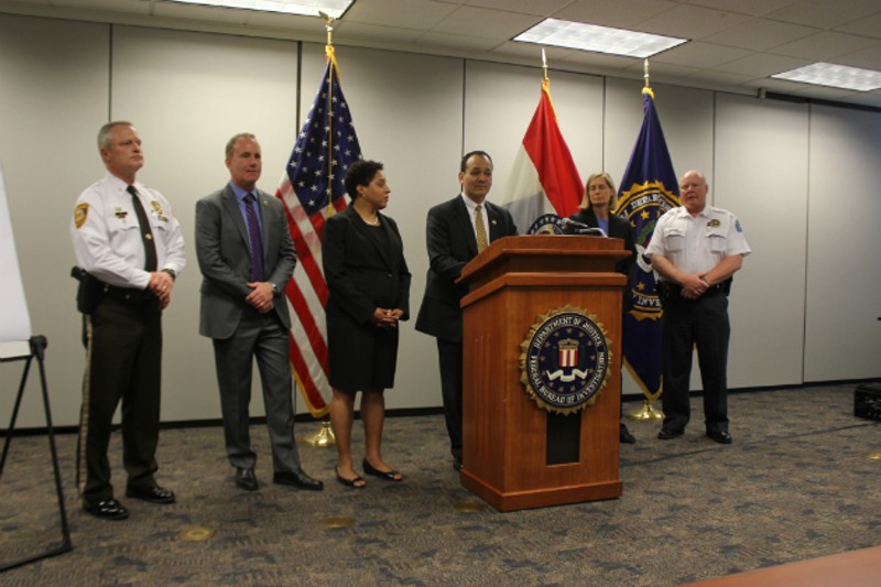 FBI Special Agent in Charge William Woods (center) and members of Mission SAVE announce indictments of alleged gang members. - Photo by Doyle Murphy
