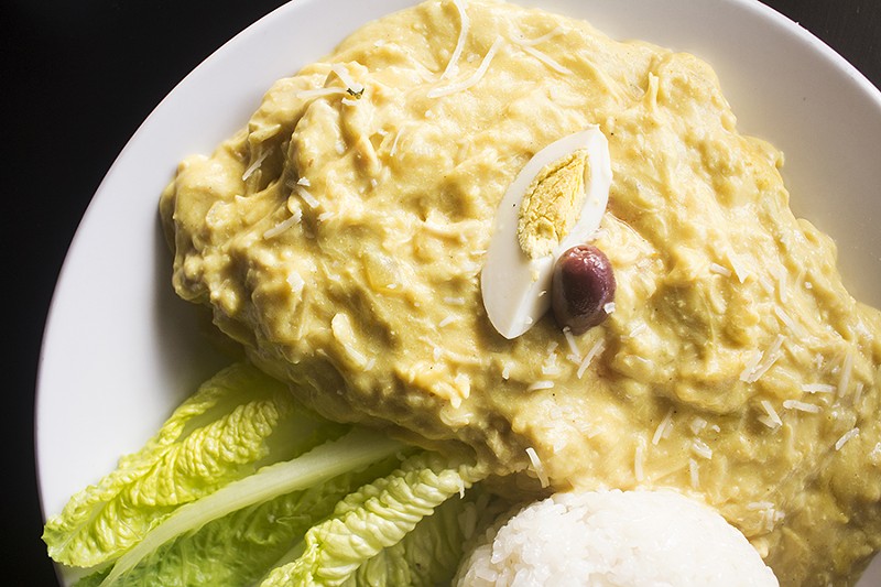 Aji de gallina includes shredded chicken, homemade Peruvian yellow sauce, sliced boiled potatoes, boiled egg and kalamata olives. - MABEL SUEN
