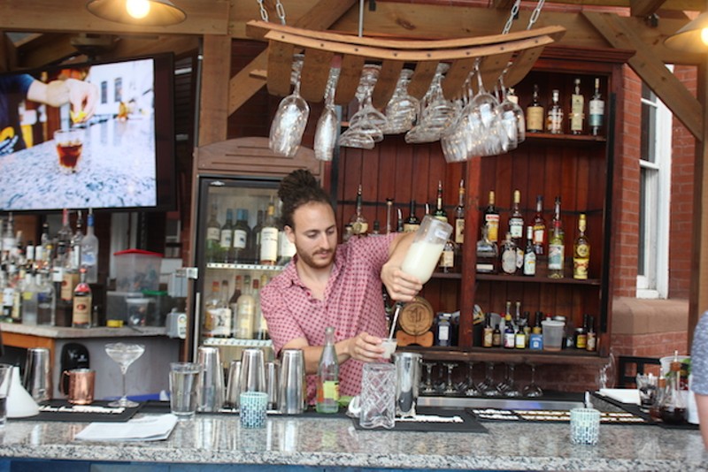 Noah Prince Goldberg mixes up one of Bronson House's complex, magical cocktails. - PHOTO BY SARAH FENSKE