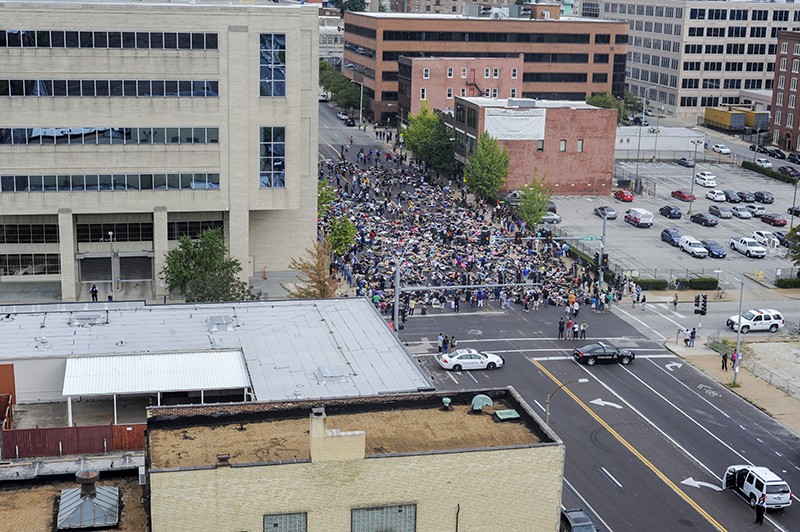Hundreds of people massed outside the St. Louis Metropolitan Police headquarters on the afternoon of Sunday, September 17. - PHOTO BY KELLY GLUECK