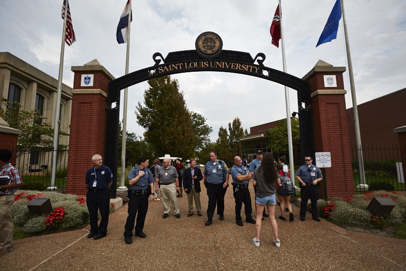 Police at St. Louis University posted at campus entrances during Sunday's protest march. - PHOTO BY THEO WELLING