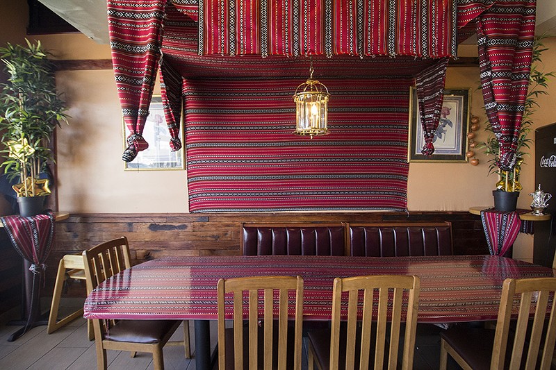 Red tapestries adorn the dining room. - PHOTO BY MABEL SUEN
