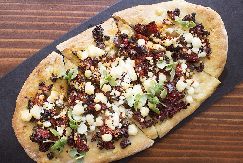 The sundried tomato flatbread is topped with oregano, feta and extra virgin olive oil. - MABEL SUEN