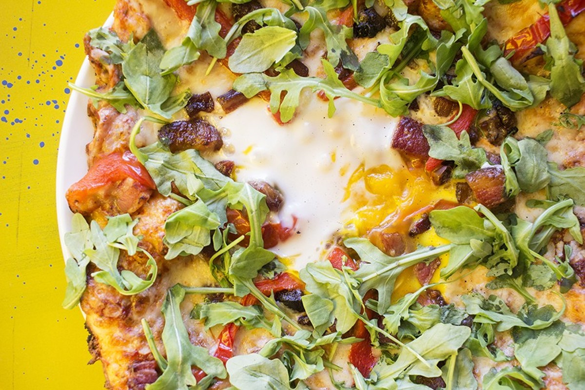 Hugo's "Farm Boy" pie is topped with arugula, roasted red pepper, shredded mozzarella, house bacon and a farm egg.