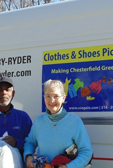 Chesterfield resident Darcy Capstick gives used clothing to a USAgain driver during one of the city's first-ever textile pickups.