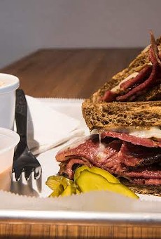 The pastrami sandwich with a side of potato salad.