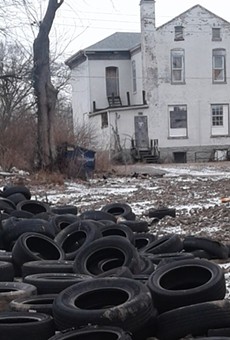 Piles of tires as they appeared in police photos of an illegal dumping site in north St. Louis.
