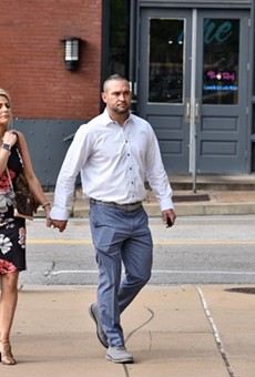 Ex-St. Louis police officer Dustin Boone walks to federal court on June 17 with his wife, Ashley Marie Boone.