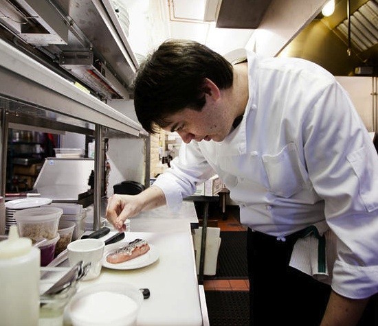 Jonathan Olson prepares one of the new dishes at Market Grill. - JENNIFER SILVERBERG