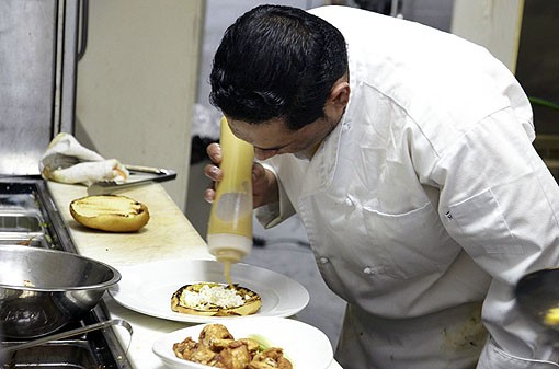 Julio putting the mustard on a chicken sandwich. See more photos from Molly's in our slideshow. - PHOTO: STEVE TRUESDELL