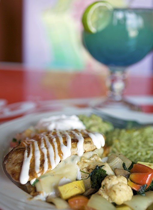 The Las Palmas stuffed chicken is chicken stuffed with spinach, mushrooms, onions, pepperjack cheese and in a spicy diablo sauce. It is served with cilantro rice, veggies, guacamole, sour cream and pico de gallo. See the full slideshow here. - PHOTO: JENNIFER SILVERBERG